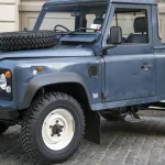 Blue 1991 Land Rover Defender 90 pickup, front three-quarter view, shown as a representative Defender