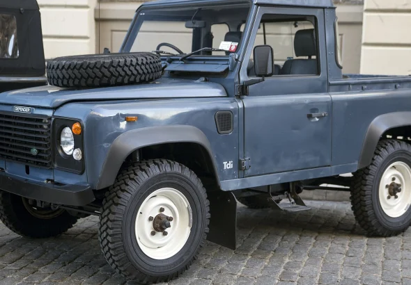 Blue 1991 Land Rover Defender 90 pickup, front three-quarter view, shown as a representative Defender