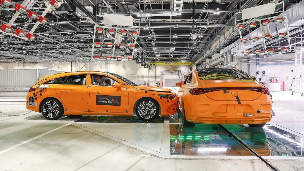 Two orange Mercedes-Benz CLA test cars after a side-impact crash test