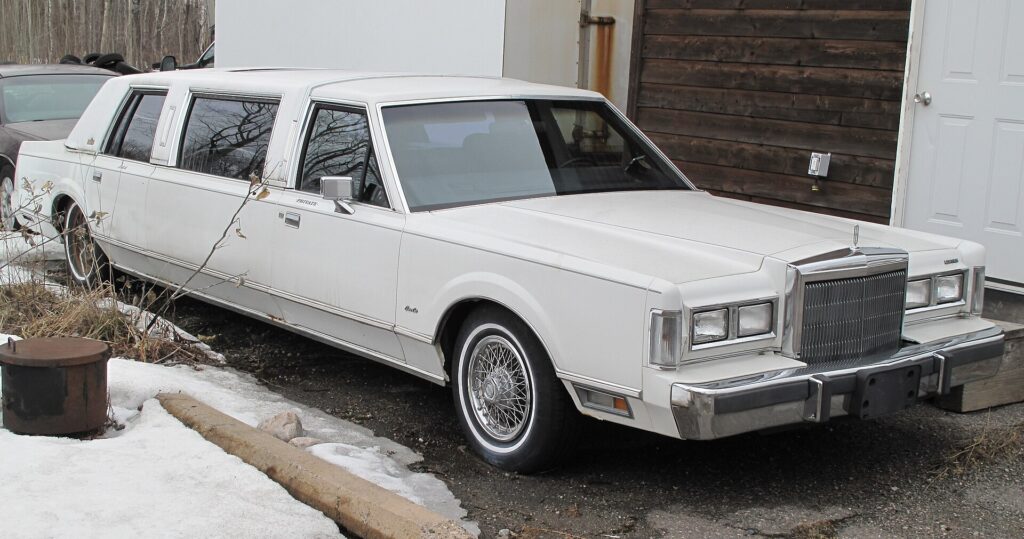 A white 1988 Lincoln Town Car stretch limousine