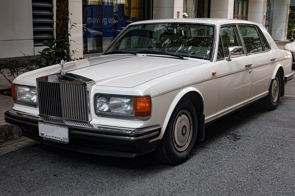 A white Rolls-Royce Silver Spur II sedan