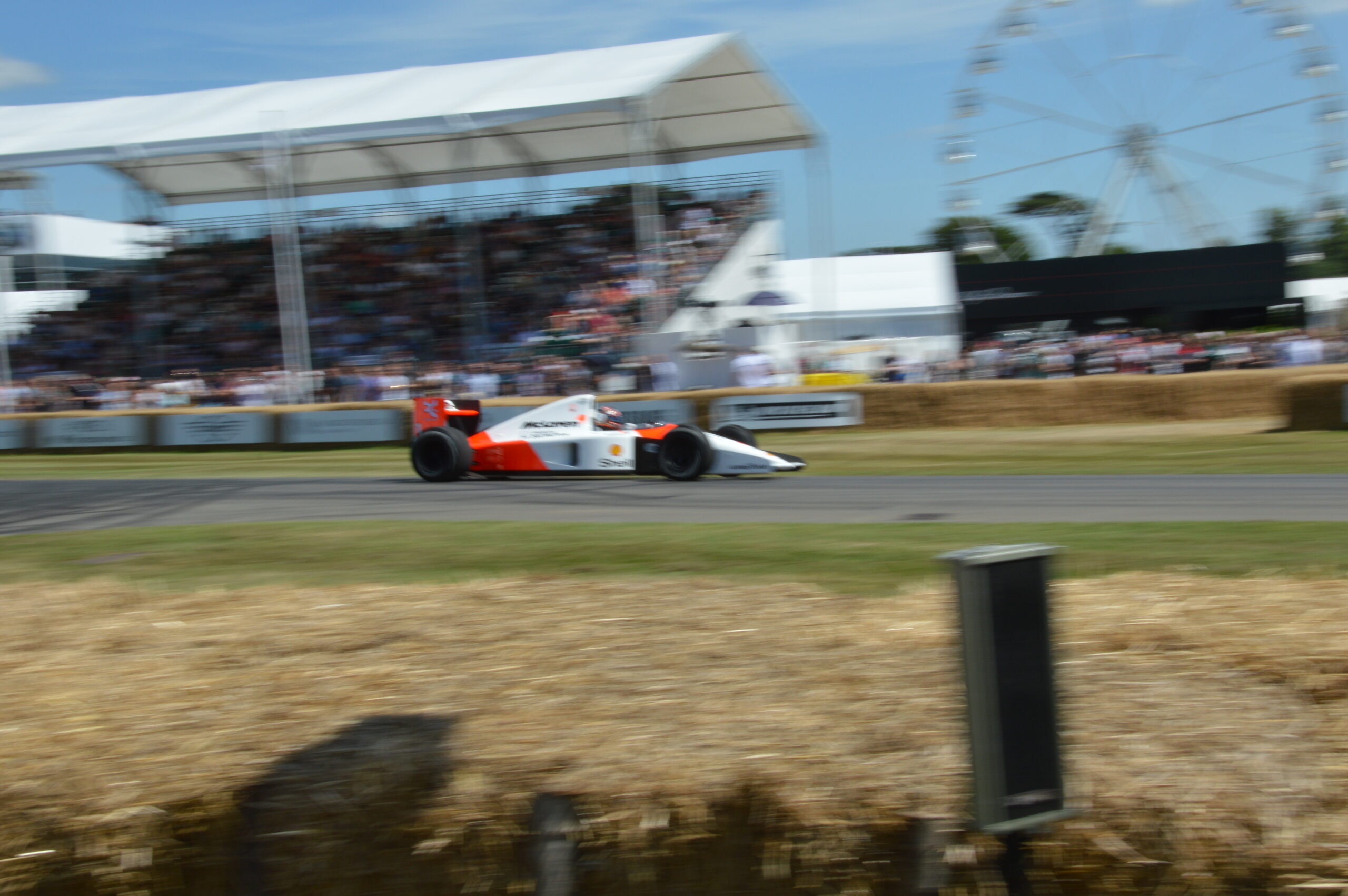 McLaren MP4/6 Formula 1 car passing a grandstand at speed