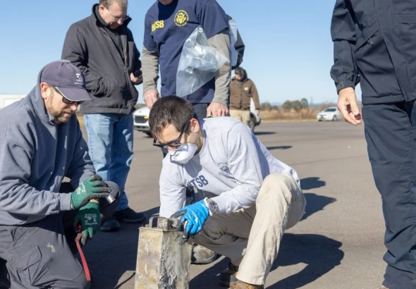 NTSB investigators recover the cockpit voice recorder from the Cessna Citation wreckage at Statesville Regional Airport