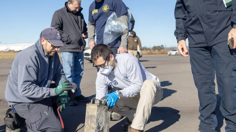 NTSB investigators recover the cockpit voice recorder from the Cessna Citation wreckage at Statesville Regional Airport