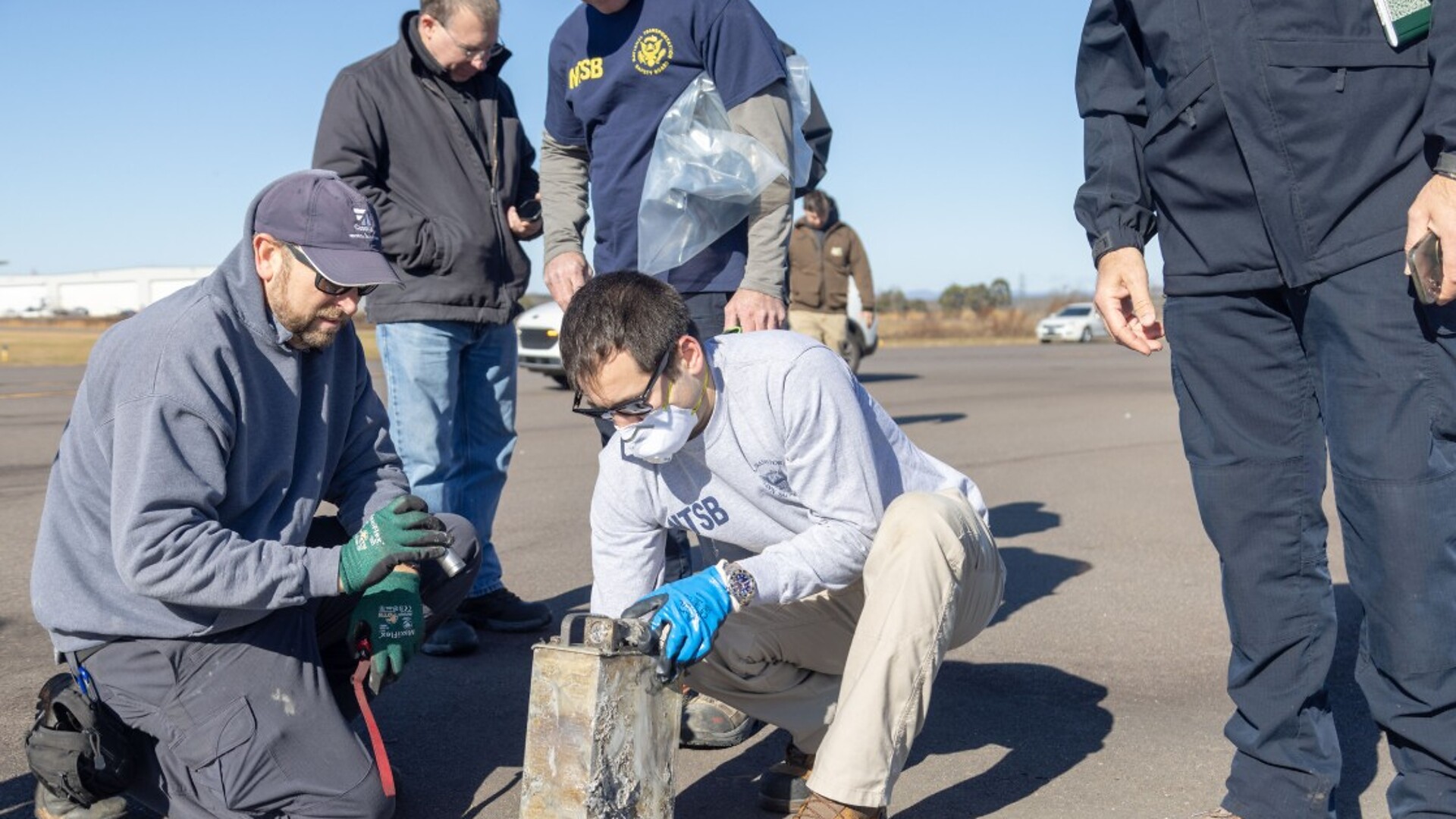 NTSB investigators recover the cockpit voice recorder from the Cessna Citation wreckage at Statesville Regional Airport
