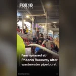 Wastewater sprays from a broken overhead pipe onto fans in the Phoenix Raceway grandstand