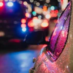 Police car with flashing lights on city street