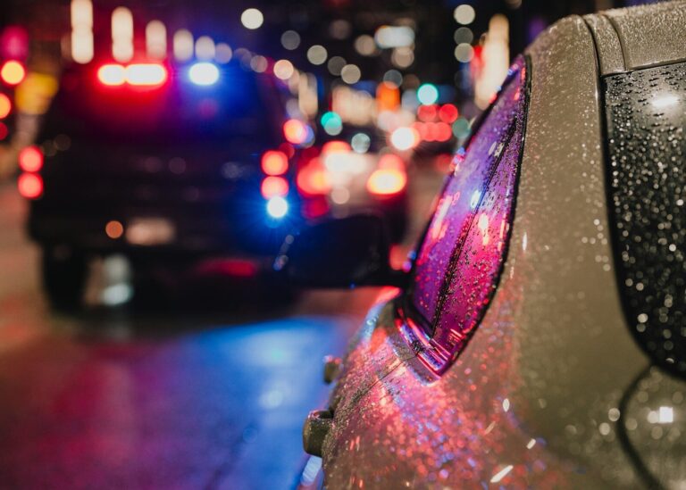Police car with flashing lights on city street