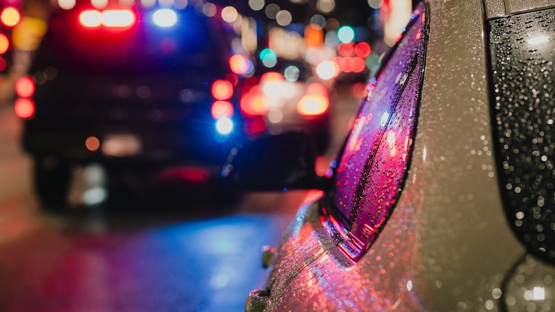 Police car with flashing lights on city street