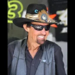 Richard Petty in his signature cowboy hat and sunglasses