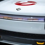 Front light bar of Rivian Ecto-R1 show car with Ghostbusters logo on the hood