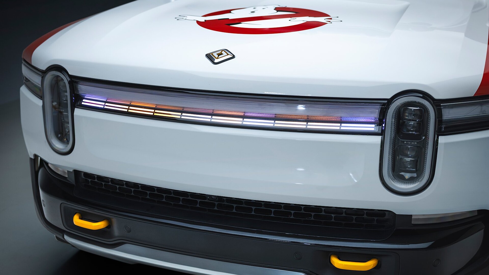 Front light bar of Rivian Ecto-R1 show car with Ghostbusters logo on the hood