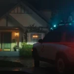 Ecto-R1 Rivian with roof lights parked outside a suburban house at night in Rivian's Ghostbusters spot
