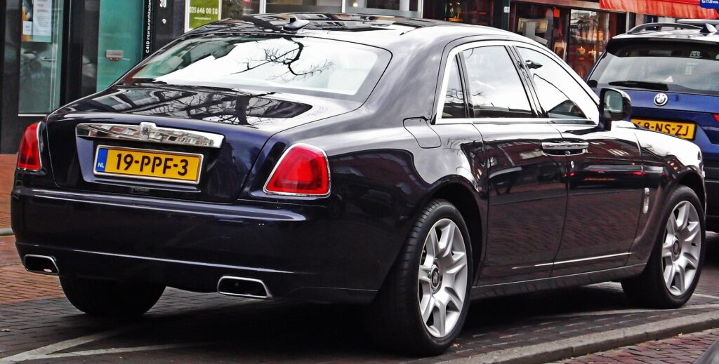 A black Rolls-Royce Ghost seen from the rear