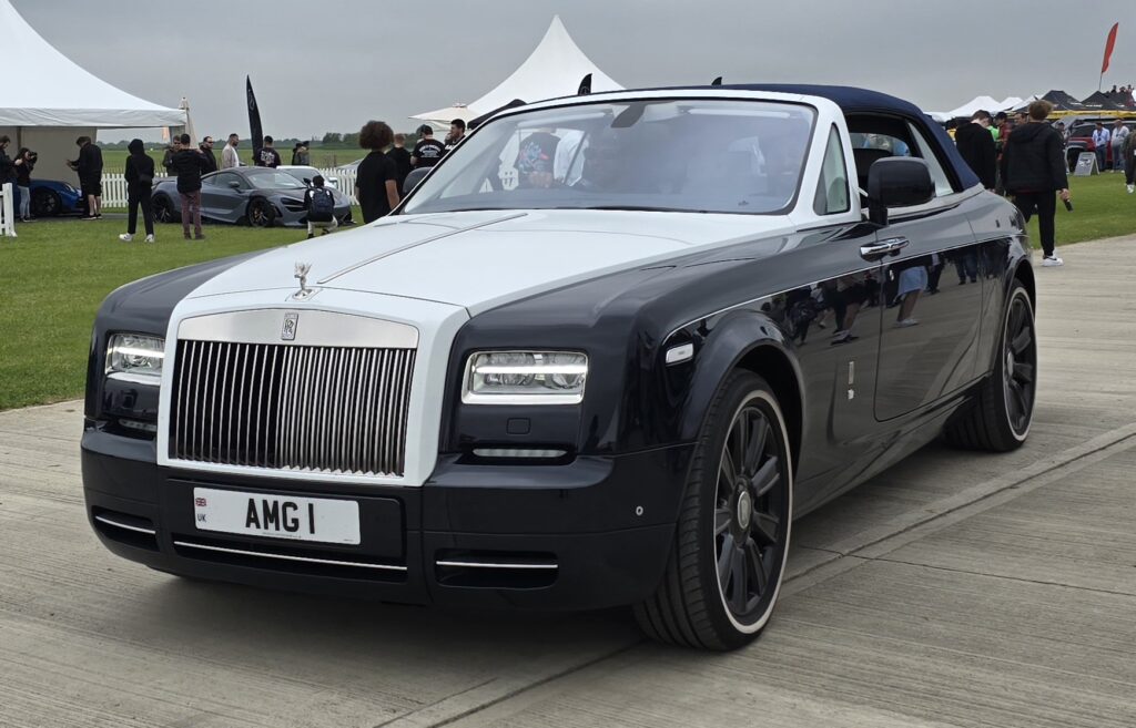 A black Rolls-Royce Phantom Drophead Coup&eacute; at a car show