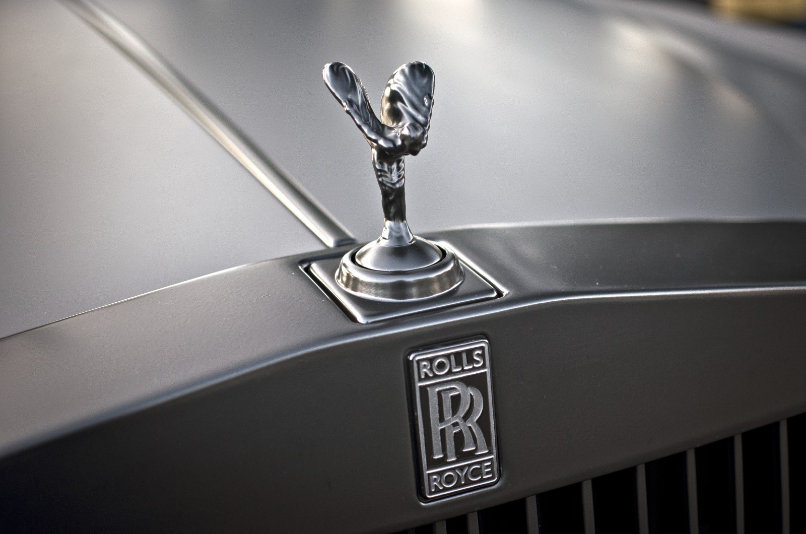 Spirit of Ecstasy hood ornament on a matte Rolls-Royce Phantom