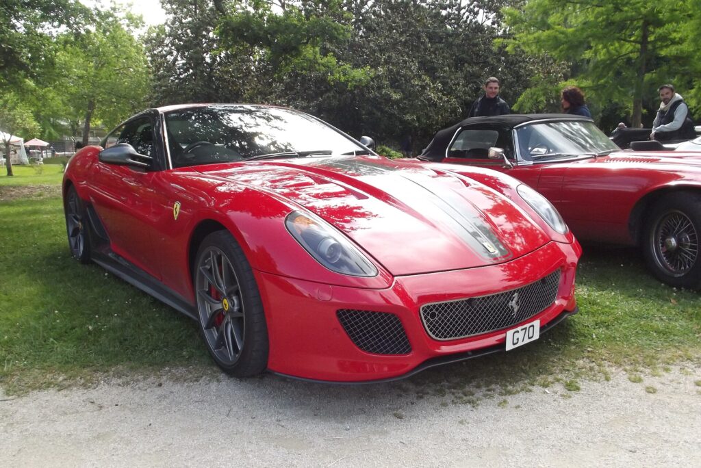 Red Ferrari 599 GTO parked on grass
