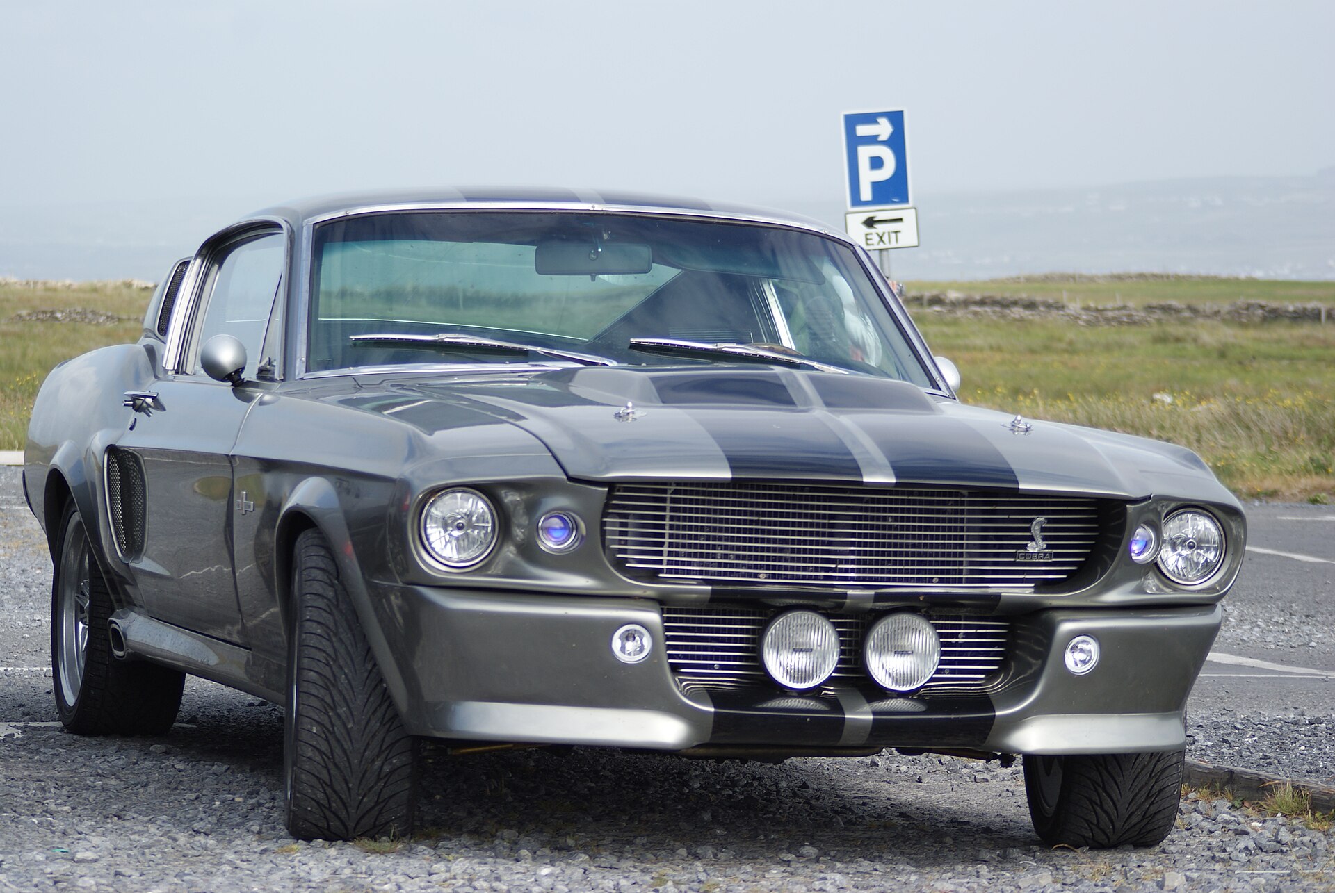 Gray 1967 Shelby Mustang GT500 Eleanor tribute with black stripes parked outdoors