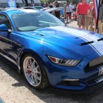 Blue Shelby Mustang Widebody Super Snake with white racing stripes, an earlier version of the car Liam Neeson drives in The Mongoose
