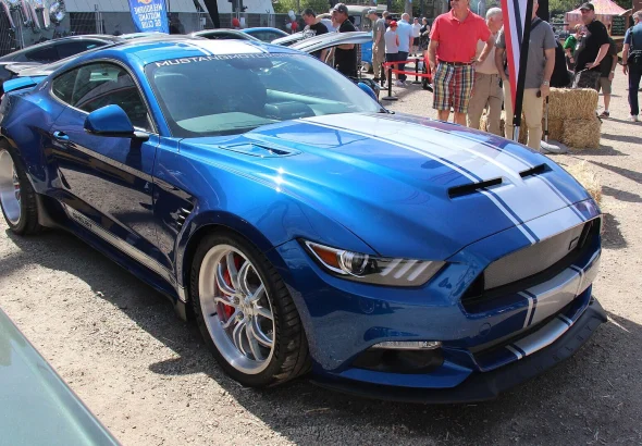 Blue Shelby Mustang Widebody Super Snake with white racing stripes, an earlier version of the car Liam Neeson drives in The Mongoose