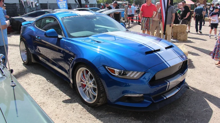 Blue Shelby Mustang Widebody Super Snake with white racing stripes, an earlier version of the car Liam Neeson drives in The Mongoose