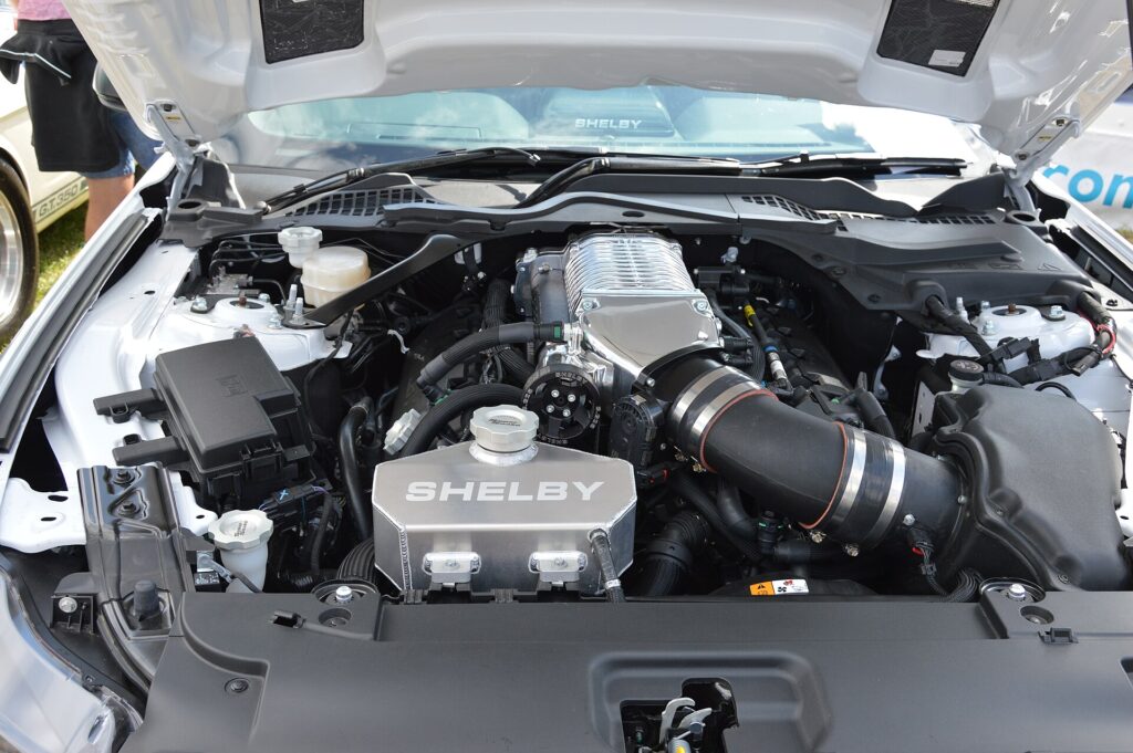 Supercharged Ford Coyote V8 engine bay of a Shelby Mustang Super Snake with Shelby-branded intake