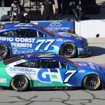 Spire Motorsports Cup Series cars on pit road at Auto Club Speedway