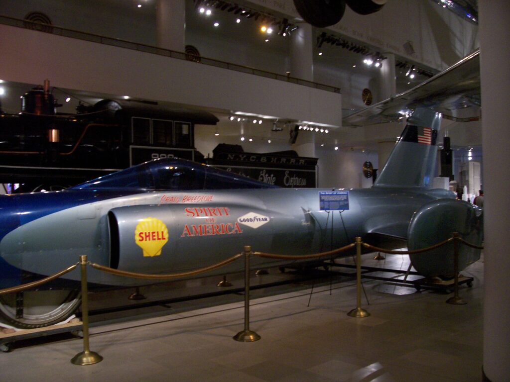 Side view of Craig Breedlove&rsquo;s silver Spirit of America jet car with Shell and Goodyear logos at Chicago&rsquo;s Museum of Science and Industry