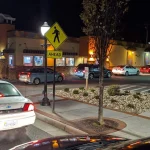 Cars lined up at a Taco Bell drive-thru at night