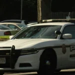 White and black police patrol car on a road