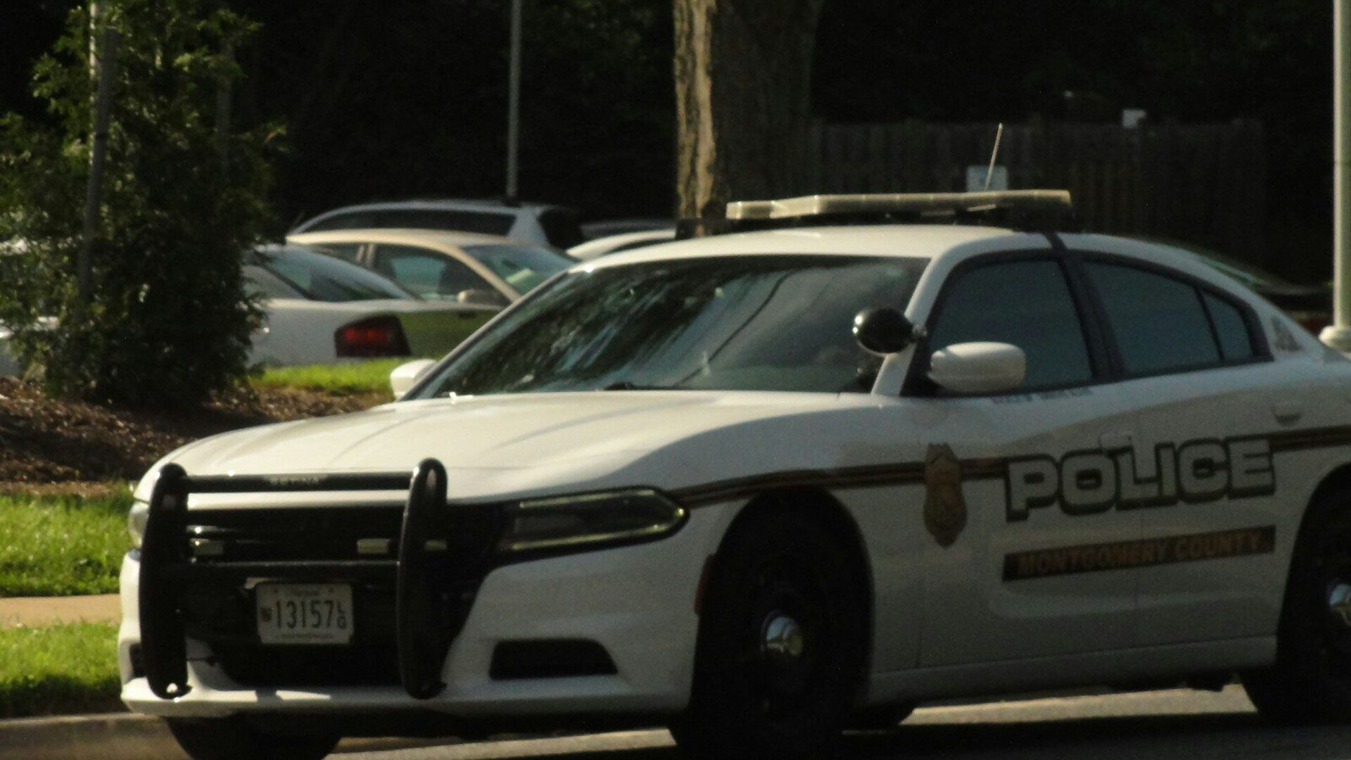White and black police patrol car on a road