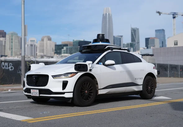 A driverless Waymo Jaguar I-Pace robotaxi on a San Francisco street
