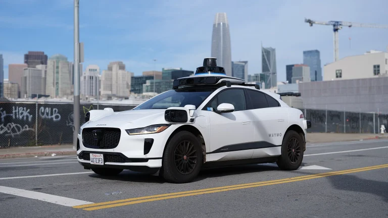 A driverless Waymo Jaguar I-Pace robotaxi on a San Francisco street
